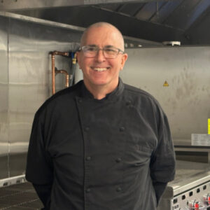 Chef George stands in the Community Kitchen