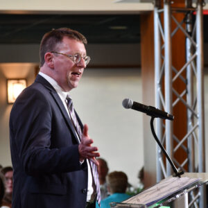 Jay Worrall speaks at a podium
